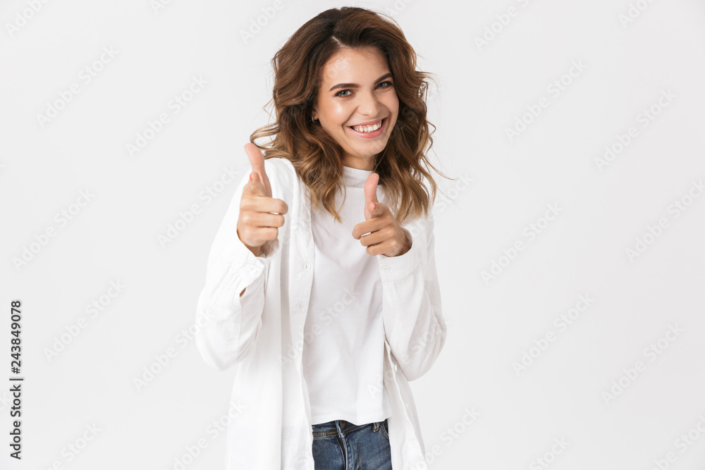 Portrait of brunette happy woman in casual clothes laughing while standing, isolated over white background Portrait of brunette happy woman in casual clothes laughing while standing, isolated over white background