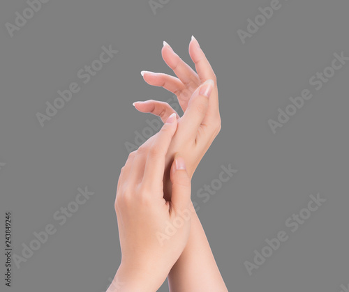 Beautiful and elegant woman hands isolated on standard neutral gray background  concept of applying moisturizing cream and body care  closeup.