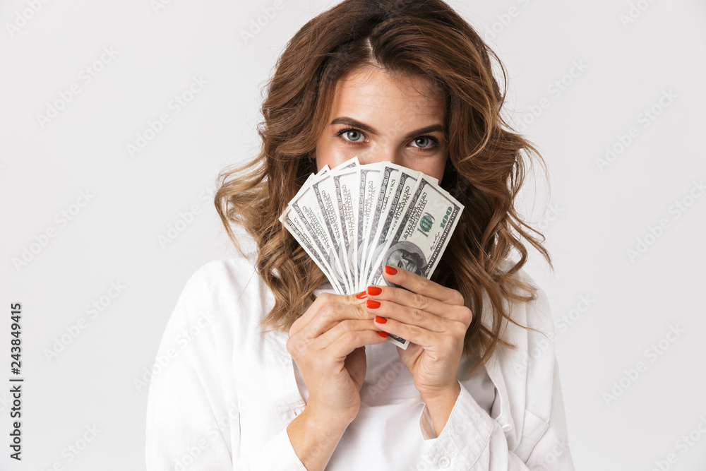 Confused young woman holding money banknotes Confused young woman holding money banknotes
