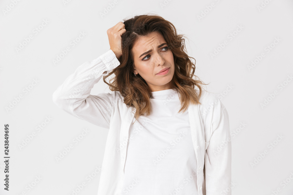 Portrait of frustrated woman 30s in casual clothes standing, isolated over white background Portrait of frustrated woman 30s in casual clothes standing, isolated over white background