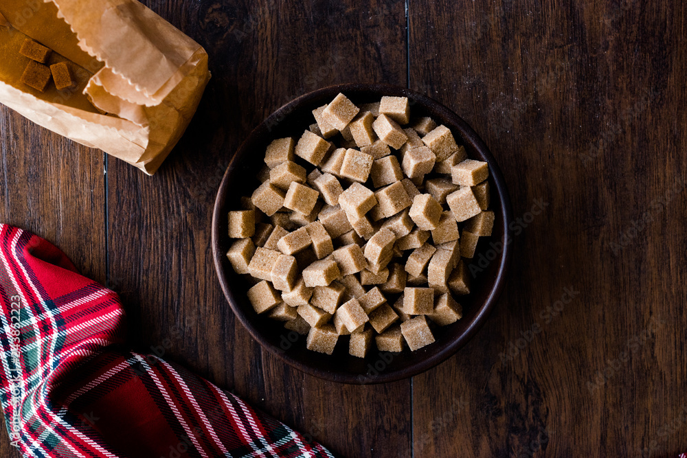 Raw Organic Brown Sugar Cubes in Wooden Bowl Ready to Eat. Raw Organic Brown Sugar Cubes in Wooden Bowl Ready to Eat.