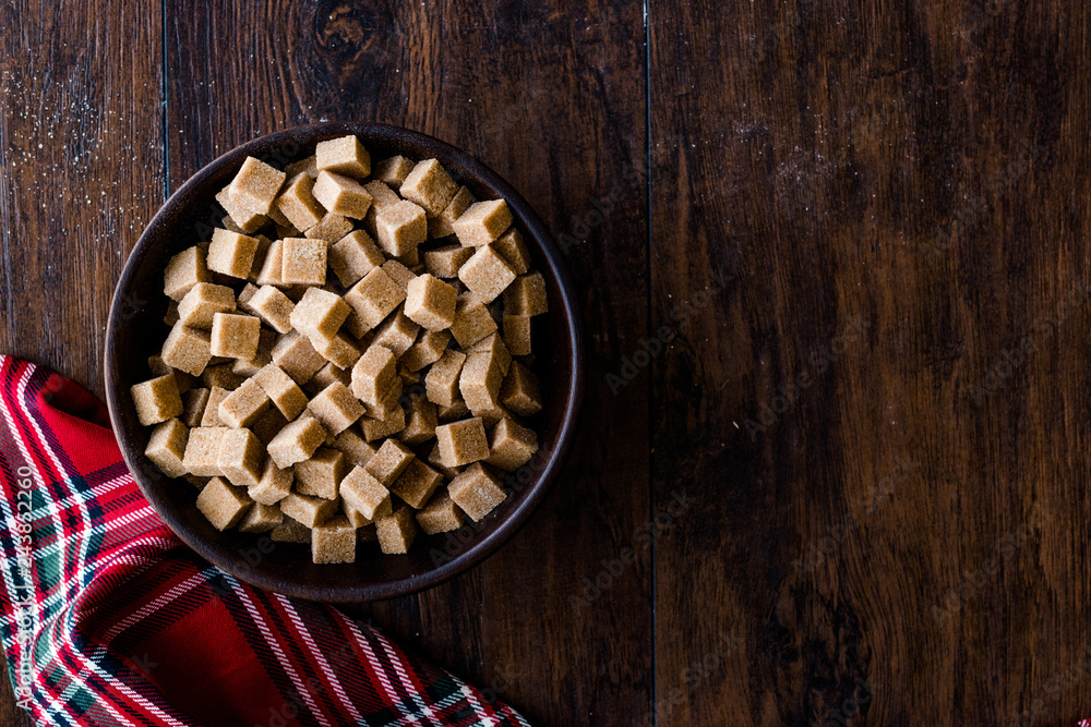 Raw Organic Brown Sugar Cubes in Wooden Bowl Ready to Eat. Raw Organic Brown Sugar Cubes in Wooden Bowl Ready to Eat.