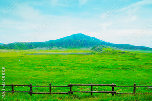 Beautiful landscape view of Kusasenri Ga Hama Grassland is green grass field for grazing with Mountain Eboshi-dake ,where is famous scenic spot in Aso Kuju National Park ,Kumamoto ,Kyushu ,Japan photo