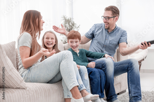 cheerful family sitting on the couch in the living room