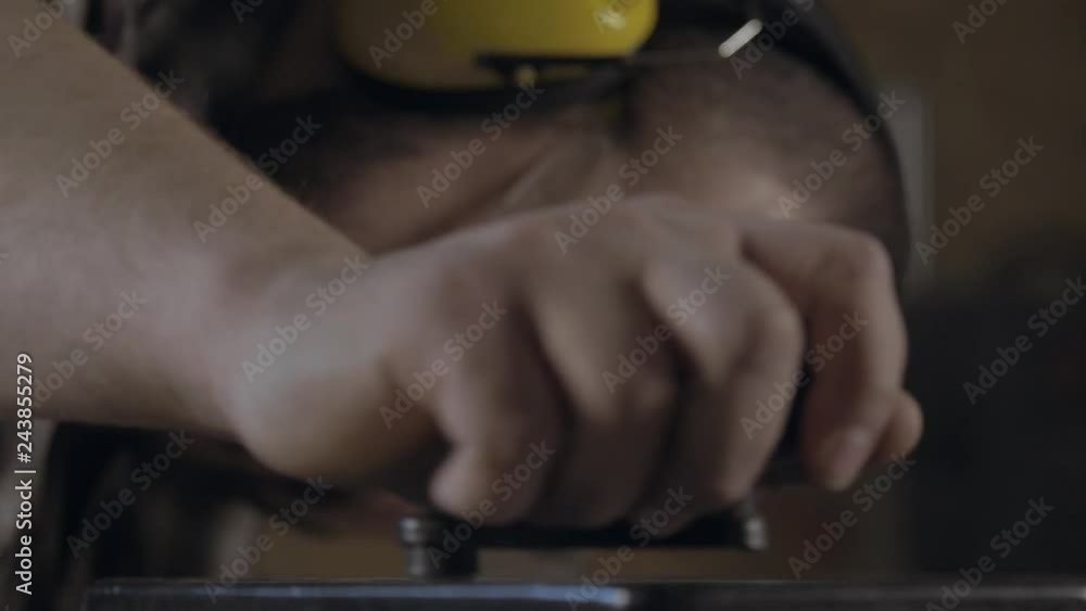 Portrait of man in safety glasses rotating and adjusting manual control lever Portrait of man in safety glasses rotating and adjusting manual control lever