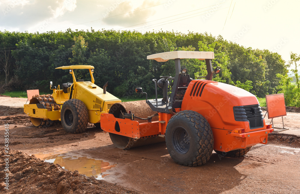 road construction with road roller / yellow and orange modern tractor roller dual working