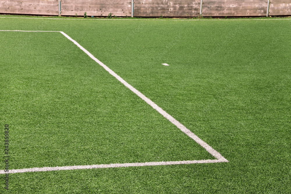 Part of sport soccer stadium and artificial turf football field. Detail, close up of green grass with white lines, goal line, corner line. Focus football field selected background, texture, wallpaper. Stock Photo | Part of sport soccer stadium and artificial turf football field. Detail, close up of green grass with white lines, goal line, corner line. Focus football field selected background, texture, wallpaper. Stock Photo |