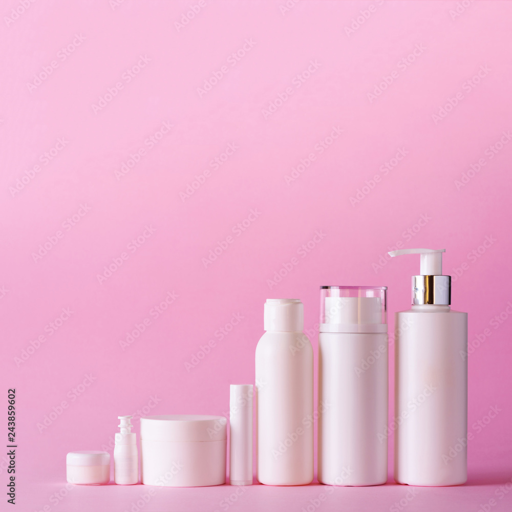 White cosmetic tubes on pink background with copy space. Skin care, body treatment, beauty concept. Square crop White cosmetic tubes on pink background with copy space. Skin care, body treatment, beauty concept. Square crop