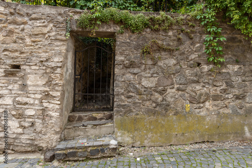 Fototapeta Naklejka Na Ścianę i Meble -  Old door on the façade of stone building