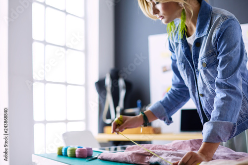 Fashion designer woman working on her designs in the studio photo