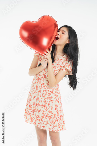 Asian young woman in red dress  red ballon heart. Young woman holding it with  being excited and surprised  holiday present isolated white  background.concept love surprise valentine day. © anon