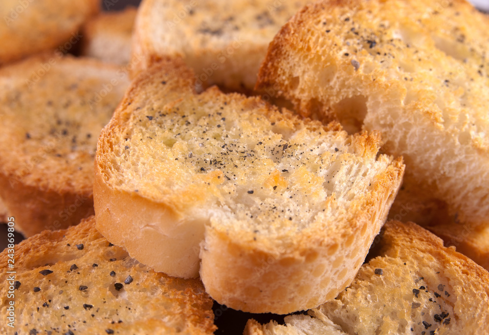Group of crispy toasted croutons with black salt