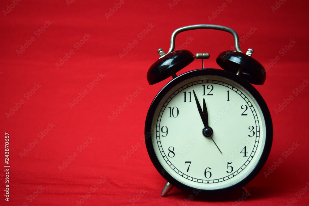 Clock ticking to 12 o'clock on the red background Clock ticking to 12 o'clock on the red background