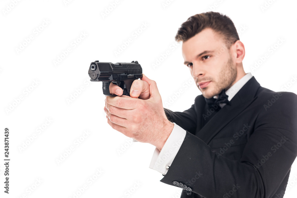 handsome serious killer in black suit aiming with handgun, isolated on white handsome serious killer in black suit aiming with handgun, isolated on white