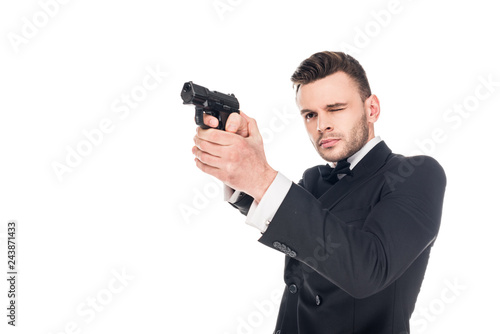 Photography dangerous killer in black suit aiming with gun, isolated on white