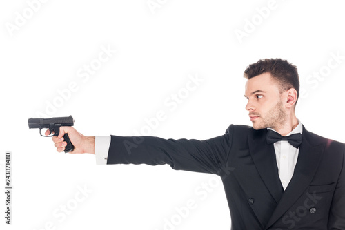 dangerous secret agent in black suit aiming with gun, isolated on white