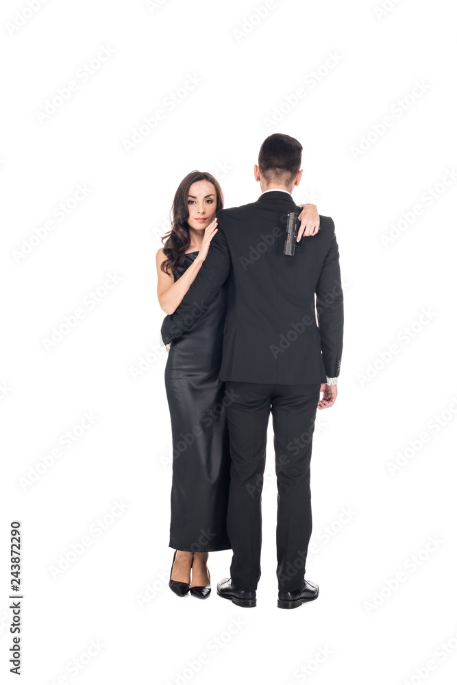 elegant couple of secret agents hugging and holding gun, isolated on white elegant couple of secret agents hugging and holding gun, isolated on white
