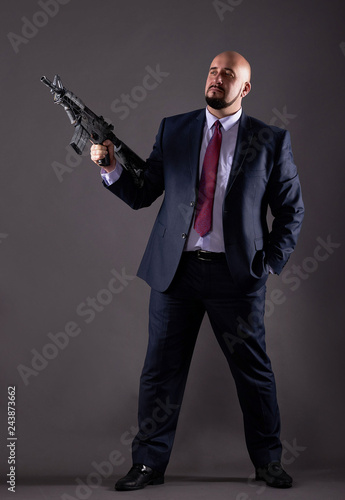 Man in a business suit with a gun © Sergey