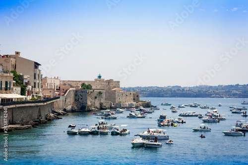 View of old street, facades of ancient buildings in seafront of Ortygia (Ortigia) Island, Syracuse, Sicily, Italy. photo