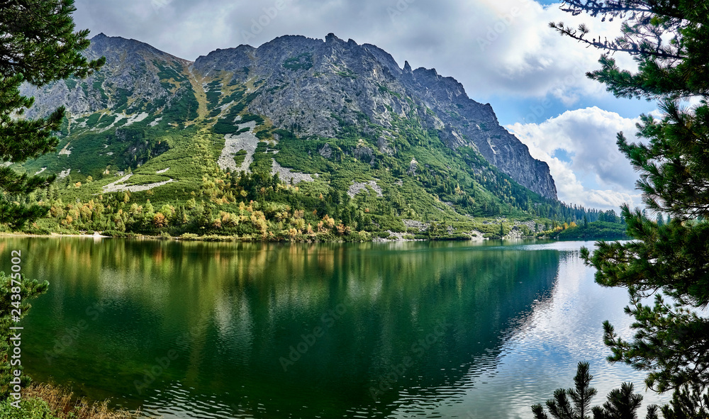 Beautiful panoramic view of Popradske pleso (once called Rybie pleso) is a mountain lake of glacial origin located in the High Tatras, Slovakia. It is situated right on the path of Tatranska magistral