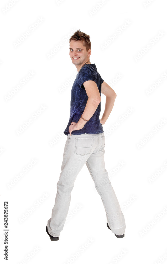 Young man in jeans standing from the back Young man in jeans standing from the back