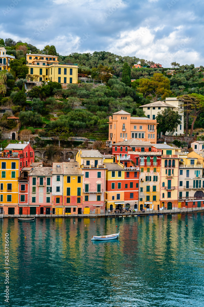 Traditional colorful mediterranean houses with boat on the sea in spectacular harbor of Portofino, Liguria, Italy