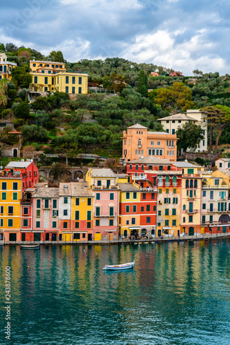 Traditional colorful mediterranean houses with boat on the sea in spectacular harbor of Portofino, Liguria, Italy