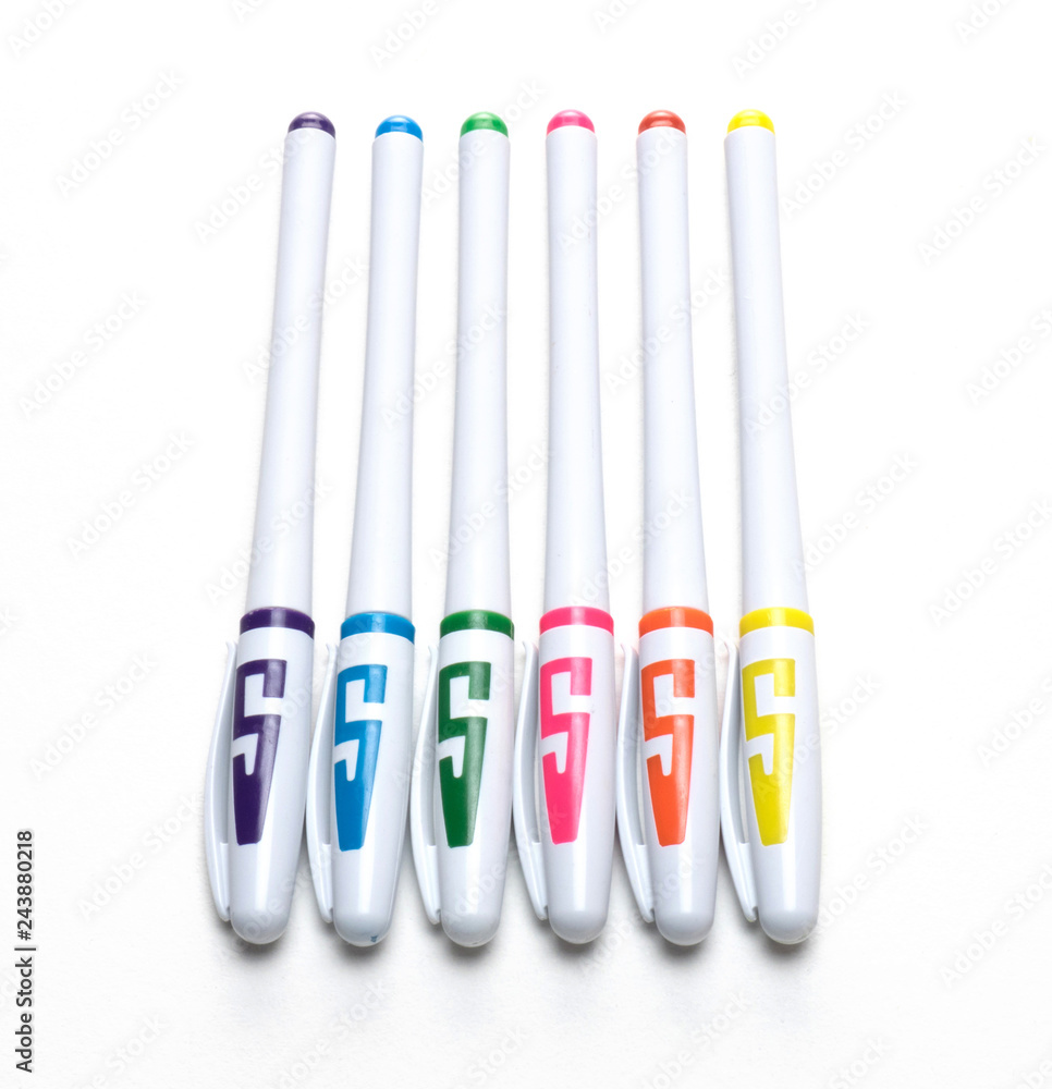 Six multi-colored ball point pens on a white background Six multi-colored ball point pens on a white background