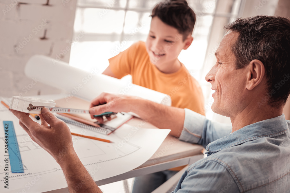 Dark-haired foster father teaching his son geometry Dark-haired foster father teaching his son geometry