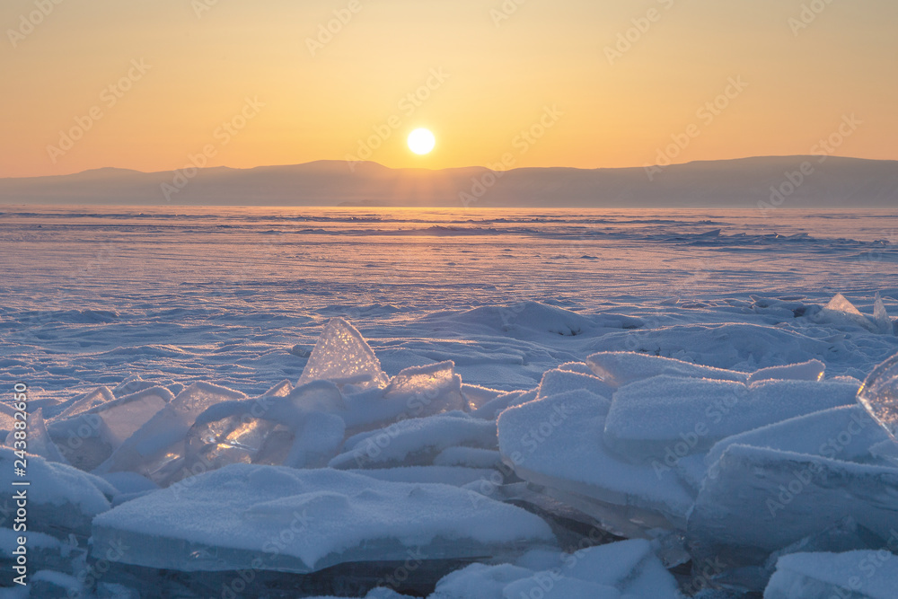 Colorful sunset over the crystal ice of Baikal lake
