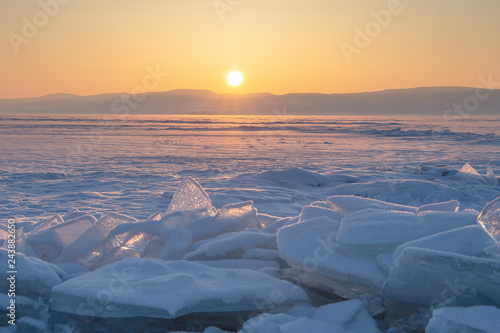 Colorful sunset over the crystal ice of Baikal lake