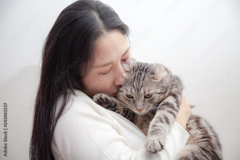 happy cat lovely comfortable sleeping by the woman kissing . love to animals concept .happy cat lovely comfortable sleeping by the woman kissing . love to animals concept .
