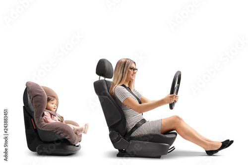 Young woman sitting in car seat and holing steering wheel photo
