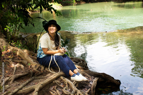 Traveler thai woman travel and posing for take photo at Chet Sao Noi small waterfalls at Muak Lek District in the Saraburi Province of Thailand. photo