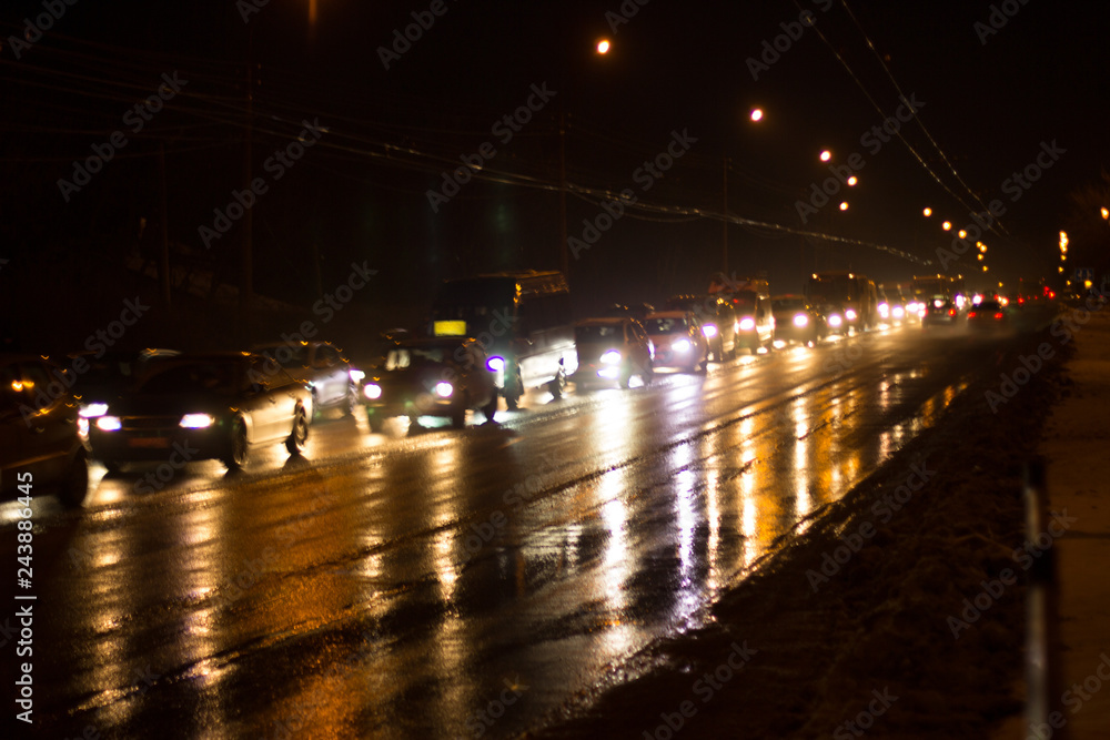 Loaded with cars by city road in the evening