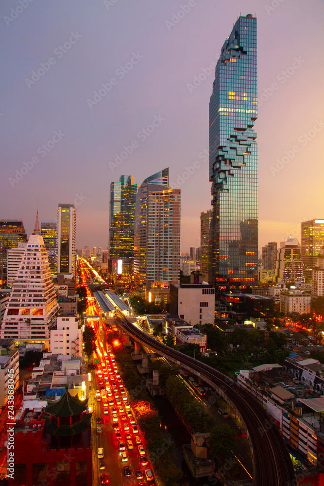 Obraz premium Aerial view Bangkok city metropolis skyline twilight sunset evening time night and modern office condominium with traffic on road beautiful Citiscape in Thailand Asia