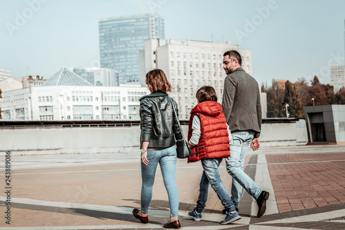 Happy young family walking together on weekends