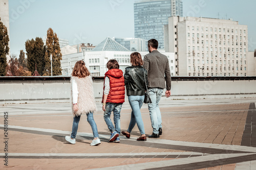 Active young family walking at the center of the city photo