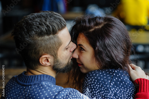 Young hipster couple in love hugging near the bonfire. Winter weather. Romantic love story