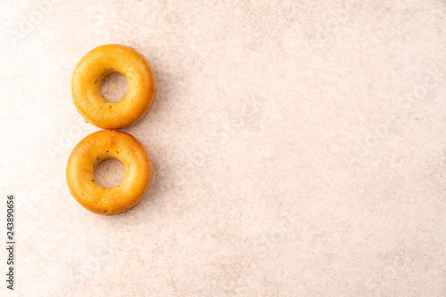 8 of March concept, two donuts on a grey stone backdrop