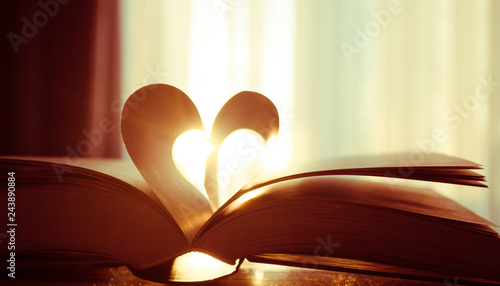 Valentine's day, heart from a book page against a beautiful sunset