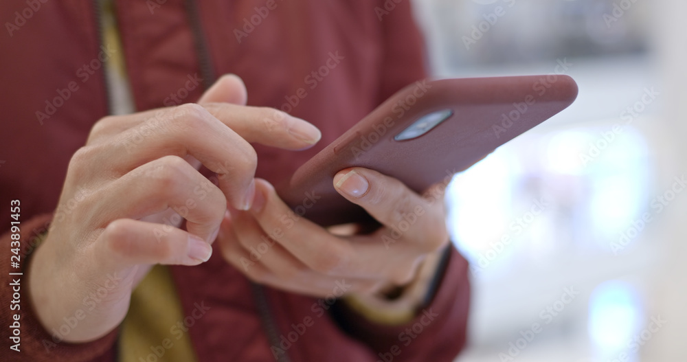 Close up of woman use smart phone inside shopping mall