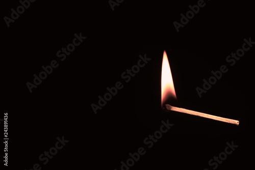 Lighted match against a black background