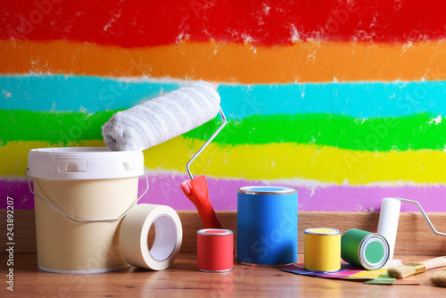 Fotografie Painting tools on parquet floor with wall painted various colors