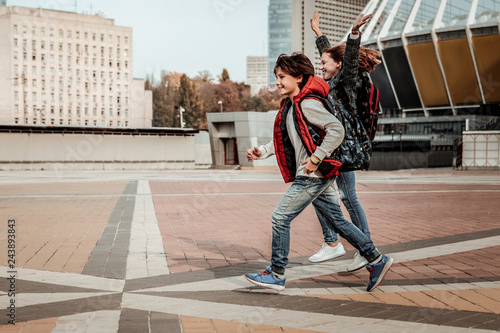 Joyful children happily running through the square photo