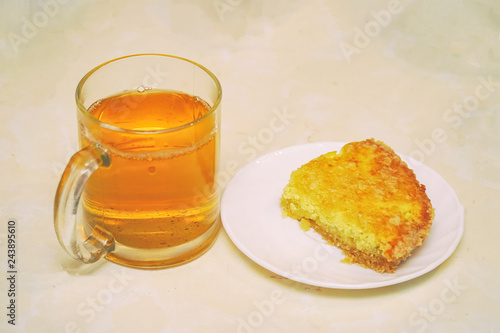 Piece of cake on a saucer and Cup of tea