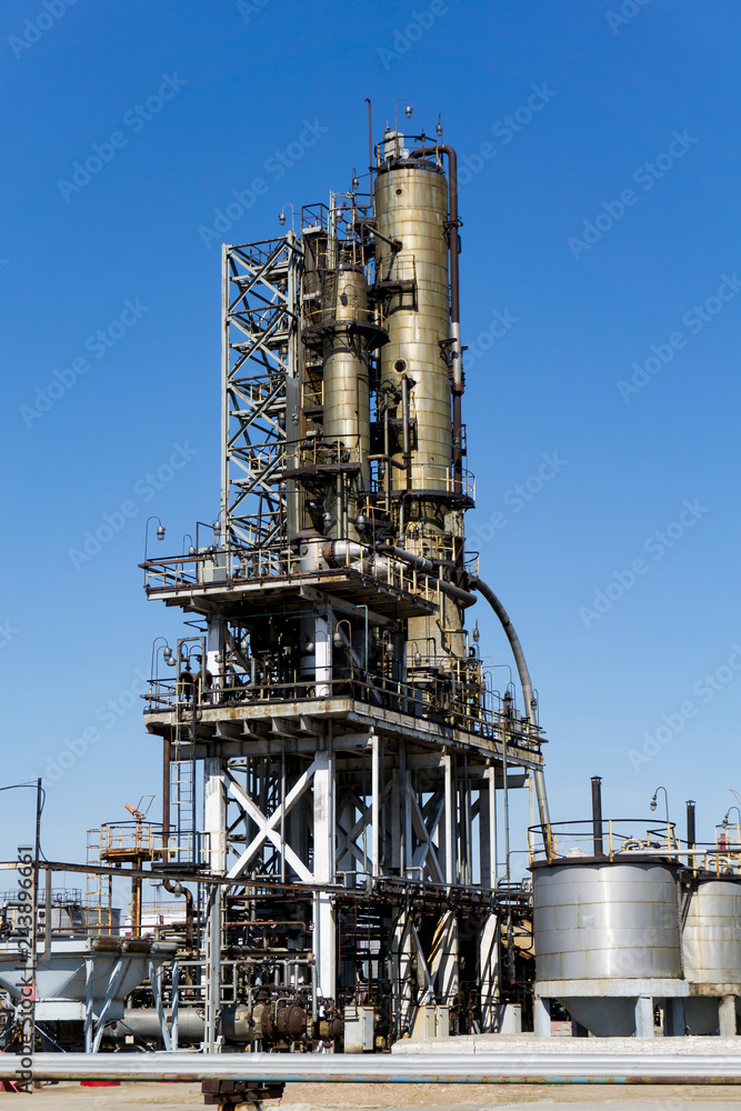 Oil refinery in Russia. equipment and complexes for hydrocarbon processing. Section of technological columns for the manufacture of gasoline, pipelines, tank.