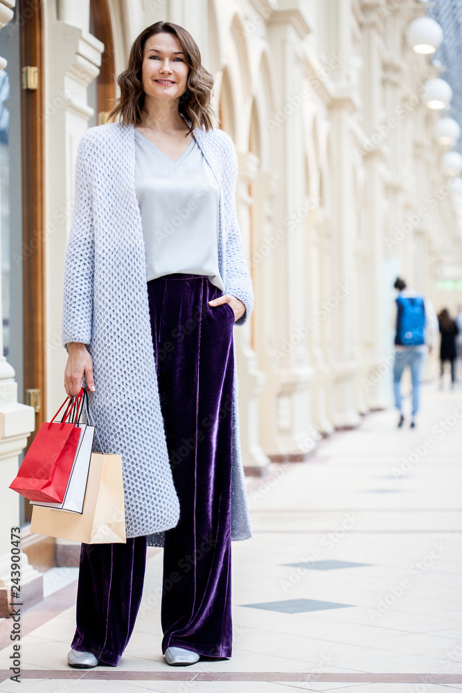 beautiful woman with shopping bags in a big store beautiful woman with shopping bags in a big store