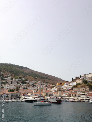 Ύδρα Idra Hydra island and port overlooking the charming town among hills in a blazing summer with intense sunshine in Greece © n3m0ado