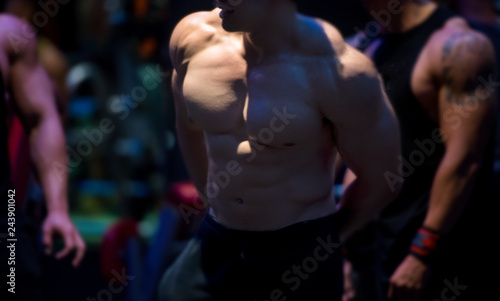 Blurred muscular bodybuilder guy in a gym © DG